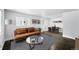 Bright living room featuring a modern sofa, stylish rug, and a dining area with a sleek table set at 1941 Alton St, Aurora, CO 80010