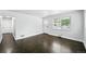 Open living room featuring hardwood floors, a bright entryway, and a sun-filled window at 1941 Alton St, Aurora, CO 80010