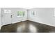 Bright living room with hardwood floors and multiple windows allowing ample natural light at 1941 Alton St, Aurora, CO 80010