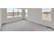 Spacious bedroom offers multiple windows and neutral carpeting at 454 Basin Daisy St, Castle Rock, CO 80104