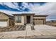 Charming single-Gathering home featuring stone pillars, a modern design and an attached two car garage at 454 Basin Daisy St, Castle Rock, CO 80104