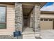 Inviting covered entryway featuring stone columns and a modern front door, offering a quick move-in ready home at 454 Basin Daisy St, Castle Rock, CO 80104