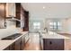 Open kitchen features a large island, stainless steel appliances and bright, natural light at 454 Basin Daisy St, Castle Rock, CO 80104