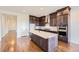 Gorgeous kitchen featuring a large island, dark wood cabinets, stainless steel appliances, and hardwood floors at 454 Basin Daisy St, Castle Rock, CO 80104