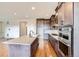 Modern kitchen with dark wood cabinets, stainless steel appliances, granite counters, and an open design at 454 Basin Daisy St, Castle Rock, CO 80104