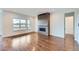 Bright living room featuring wood floors, fireplace with tile surround, and a large window at 454 Basin Daisy St, Castle Rock, CO 80104