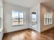 Bright living room has large windows, a door to the deck and hardwood floors at 454 Basin Daisy St, Castle Rock, CO 80104