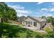 Landscaped backyard with well-maintained lawn, fencing, and patio area at 3092 Fox Sedge Pl, Highlands Ranch, CO 80126