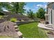 Landscaped backyard with tiered retaining wall and concrete patio area provides a relaxing outdoor space at 3092 Fox Sedge Pl, Highlands Ranch, CO 80126
