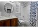 Well-lit bathroom features a vanity with marble countertop, framed mirror, and shower with blue patterned curtain at 3092 Fox Sedge Pl, Highlands Ranch, CO 80126