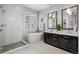 Modern bathroom with a glass-enclosed shower, soaking tub, dual sink vanity, and contemporary fixtures at 3092 Fox Sedge Pl, Highlands Ranch, CO 80126