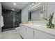 Elegant bathroom featuring a double vanity and glass-enclosed shower at 3092 Fox Sedge Pl, Highlands Ranch, CO 80126