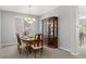 Formal dining room featuring a classic china cabinet, elegant chandelier, and dining set for six at 3092 Fox Sedge Pl, Highlands Ranch, CO 80126
