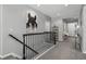Upstairs hallway featuring an art piece and access to bedrooms and other living spaces at 3092 Fox Sedge Pl, Highlands Ranch, CO 80126