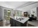 Open-concept kitchen with island cooktop, eat-in nook and seamless flow into the living room at 3092 Fox Sedge Pl, Highlands Ranch, CO 80126
