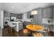 Modern eat-in kitchen featuring gray cabinets, stainless steel appliances, and an island with seating at 3092 Fox Sedge Pl, Highlands Ranch, CO 80126