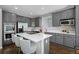 Stylish kitchen with gray cabinets, stainless steel appliances, a large island, and bar stool seating at 3092 Fox Sedge Pl, Highlands Ranch, CO 80126