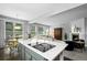 Bright kitchen featuring a cooktop island, breakfast nook, and open floor plan leading to the living area at 3092 Fox Sedge Pl, Highlands Ranch, CO 80126
