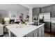 Modern kitchen featuring stainless steel appliances, stone countertops, and stylish gray cabinetry at 3092 Fox Sedge Pl, Highlands Ranch, CO 80126