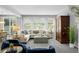 Bright and airy living room with large windows, plush seating, and stylish decor at 3092 Fox Sedge Pl, Highlands Ranch, CO 80126