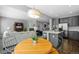 Open-concept floor plan with kitchen island and eating area overlooking the living space and fireplace at 3092 Fox Sedge Pl, Highlands Ranch, CO 80126