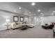 Spacious living room with cozy sectional, elegant decor, and recessed lighting at 3092 Fox Sedge Pl, Highlands Ranch, CO 80126