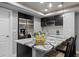 Convenient wet bar area with stainless-steel refrigerator and granite countertops at 3092 Fox Sedge Pl, Highlands Ranch, CO 80126