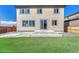 Home backyard with a concrete patio, steps, and lush artificial turf at 15902 Stringhalt Way, Parker, CO 80134