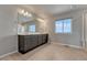 Elegant primary bathroom with double sink vanity, ample storage, and a large bright window at 15902 Stringhalt Way, Parker, CO 80134