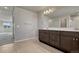 Bathroom with dual vanity, wood cabinetry, and plenty of storage space at 15902 Stringhalt Way, Parker, CO 80134