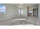 Bright bedroom featuring carpet and two windows offering views of the outside at 15902 Stringhalt Way, Parker, CO 80134