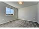 Bedroom with a window showcasing the outside view and soft, neutral carpet at 15902 Stringhalt Way, Parker, CO 80134