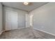 Bedroom featuring carpet, closet with bi-fold doors, and entry doorway at 15902 Stringhalt Way, Parker, CO 80134
