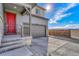 Sunlit exterior showcasing a well-maintained home, driveway, and charming front porch at 15902 Stringhalt Way, Parker, CO 80134
