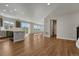 Spacious open layout combining kitchen and living space with bright windows and hard wood floors at 15902 Stringhalt Way, Parker, CO 80134