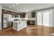 Modern kitchen featuring a large island, stainless steel appliances, and bright natural light at 15902 Stringhalt Way, Parker, CO 80134