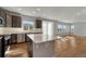 Bright kitchen featuring a quartz countertop island with a view of the backyard through sliding doors at 15902 Stringhalt Way, Parker, CO 80134