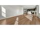 Spacious living area with hardwood floors, an open concept kitchen, and bright natural light at 15902 Stringhalt Way, Parker, CO 80134
