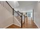 Open-concept living room and staircase with hardwood floors and neutral paint at 15902 Stringhalt Way, Parker, CO 80134