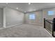 Upstairs living room with neutral carpet, natural light, and access to staircase at 15902 Stringhalt Way, Parker, CO 80134