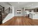 Inviting living room view with a staircase, featuring hardwood floors and ample natural light at 15902 Stringhalt Way, Parker, CO 80134