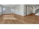 Bright living room featuring wood floors, neutral walls, and natural light from two windows at 15902 Stringhalt Way, Parker, CO 80134