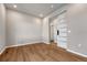 Main-floor office with wood floors, recessed lighting, and a modern sliding panel door at 15902 Stringhalt Way, Parker, CO 80134