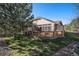 View of backyard with patio, stucco house and trees at 1660 Moveen Hts, Monument, CO 80132