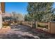 Backyard patio with brick firepit, stucco house, and manicured landscaping at 1660 Moveen Hts, Monument, CO 80132