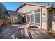 Backyard patio with firepit, stucco house and view of backyard landscaping at 1660 Moveen Hts, Monument, CO 80132