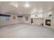 Finished basement area featuring a fireplace, built-in shelving, and three windows for natural light at 1660 Moveen Hts, Monument, CO 80132