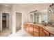 Primary bathroom with dual sinks and separated shower room with glass block details at 1660 Moveen Hts, Monument, CO 80132