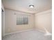 Carpeted bedroom featuring neutral paint, base trim, and window for natural light at 1660 Moveen Hts, Monument, CO 80132
