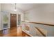 Bright foyer features hardwood floors, a wood door, and an open staircase to the basement at 1660 Moveen Hts, Monument, CO 80132